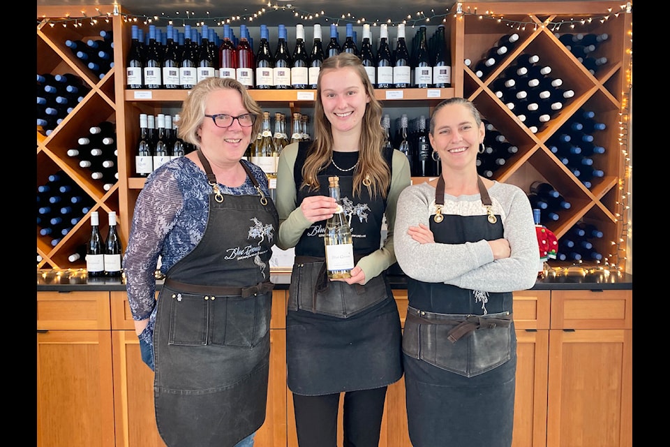 Blue Grouse will be offering unique and interactive tasting experiences in their tasting room through January and February. Tasting Room manager Pamela Sanderson, left, tasting room associate Brooklynn Kew, and assistant manager Genevieve Charbonneau pose with a bottle of one of their top sparkling wines.