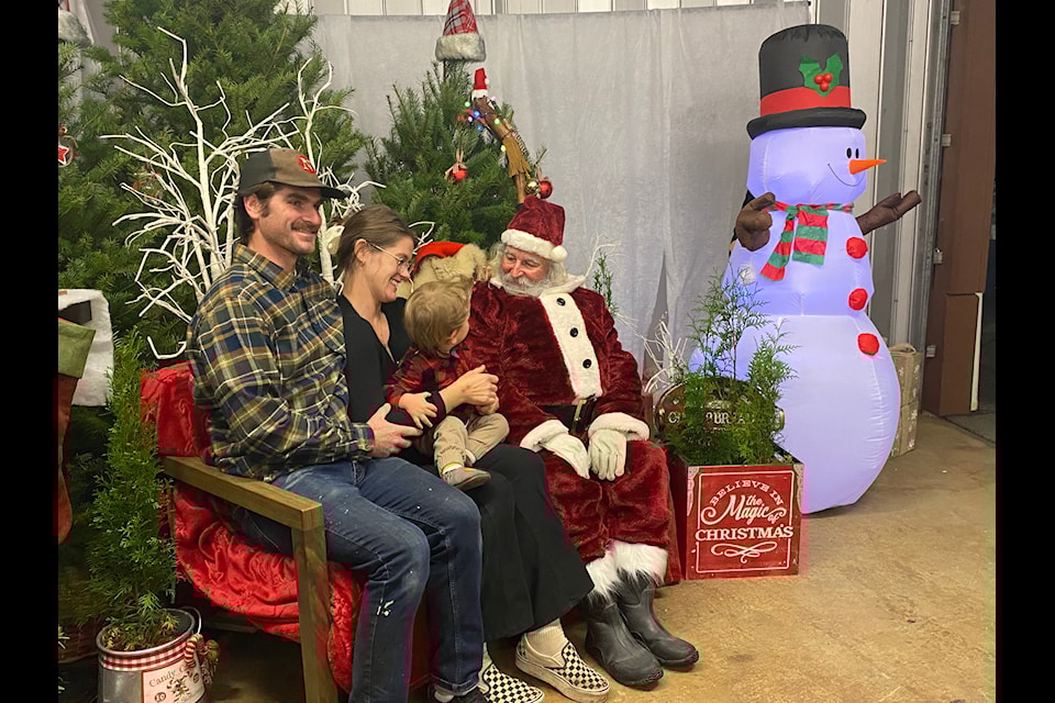 The Barry family, mom, dad and Rupert, who is one, pose with Santa Claus at the North Pole on Sunday night.  
