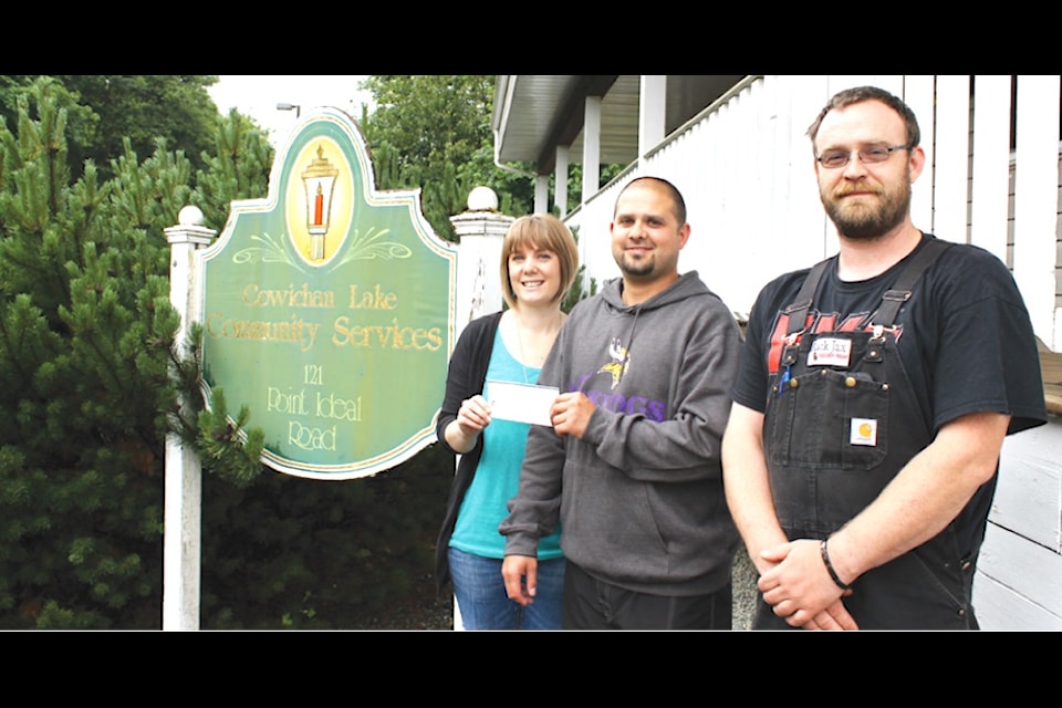 'Stephen Nahirick and BJ Sihota from the Kinsmen Club present a $5,000 cheque to Sarah DeBodt of Community Services. On Friday, June 27 two members of the Lake Cowichan Kinsmen Club were at Lake Cowichan Community Services with a $5,000 cheque for the organization. The money was raised by the Kinsmen from fundraising events during the year. The funds will be used by Community Services for their Summer Camp programs. The local Kinsmen have been donating funds for the summer programs for over 20 years.'