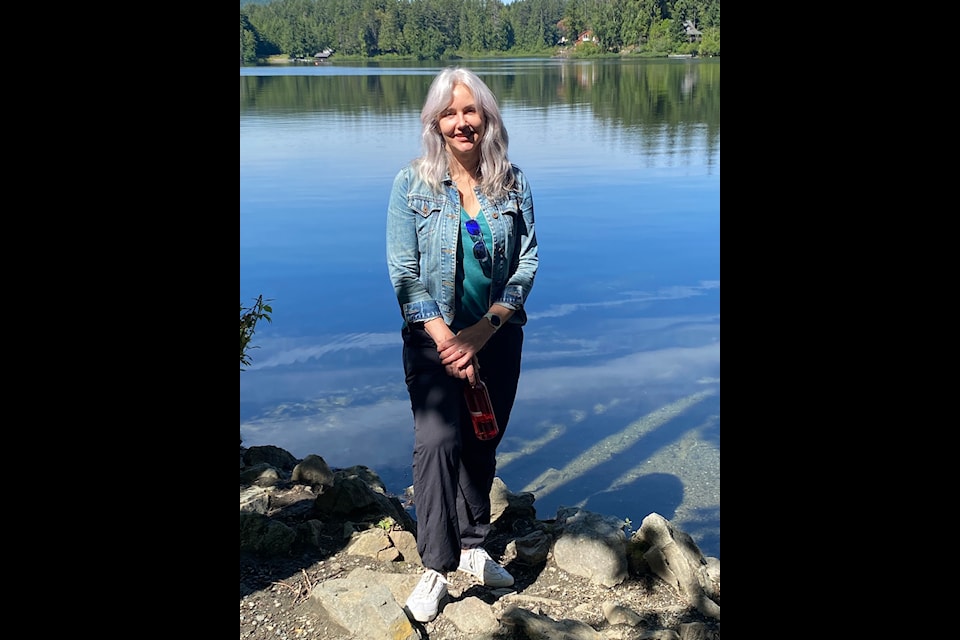 Area B director Sierra Acton stands at a spot at Shawnigan Lake that happens to be the inspiration and backdrop for one of her personal paintings.  