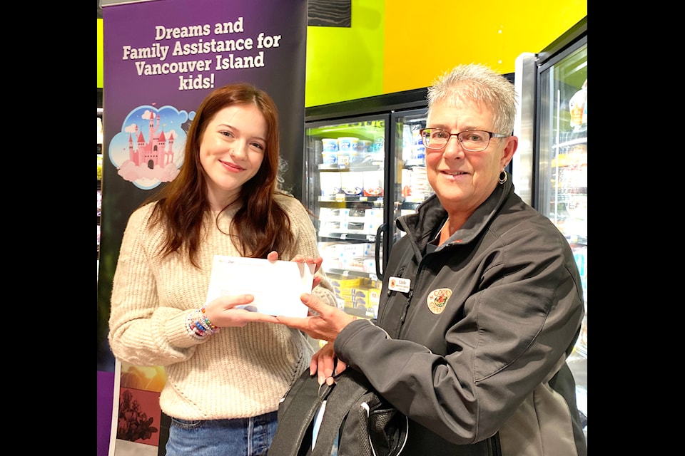 Country Grocer public relations spokesperson Linda K. presents 18-year-old Kayla Dosen with her two tickets to see her idol Taylor Swift in concert next month.