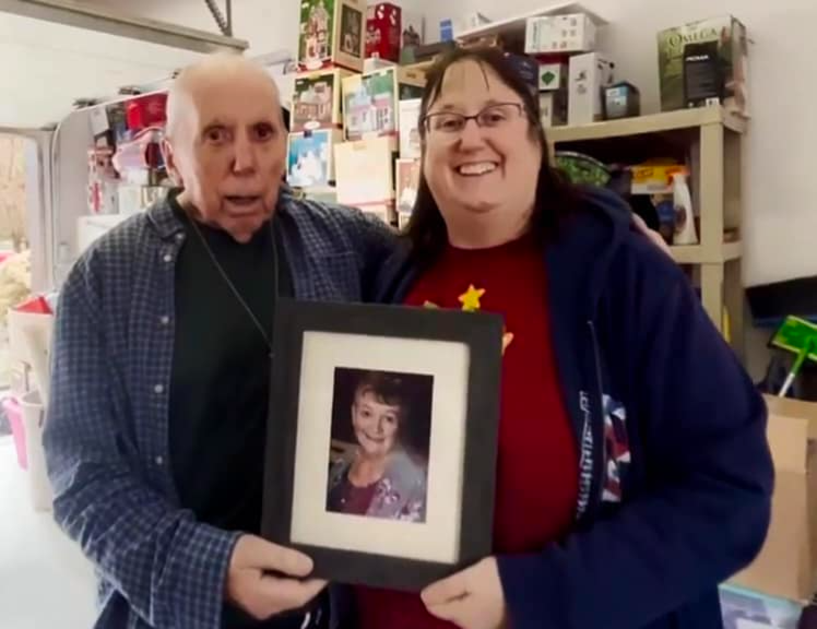 Marcia Jones and her father Dennis hold a photo of Donna Jones who sadly lost her battle to cancer in 2023. While it was a hard decision they feel comfort knowing that they can share her love of Christmas with others, and raised over $3,400 for cancer care in doing so.