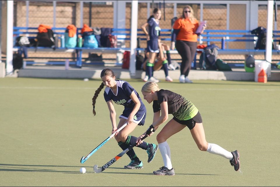 Players from QMS and Quamichan battle for the ball during the first game of the annual Ferreira field hockey tournament on Sept. 27.
