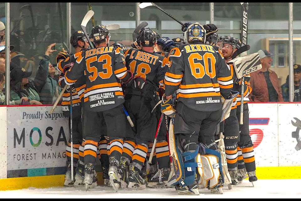 The Lake Cowichan Appollos celebrate an overtime win after their first game in a decade at the Cowichan Lake Sports Arena.