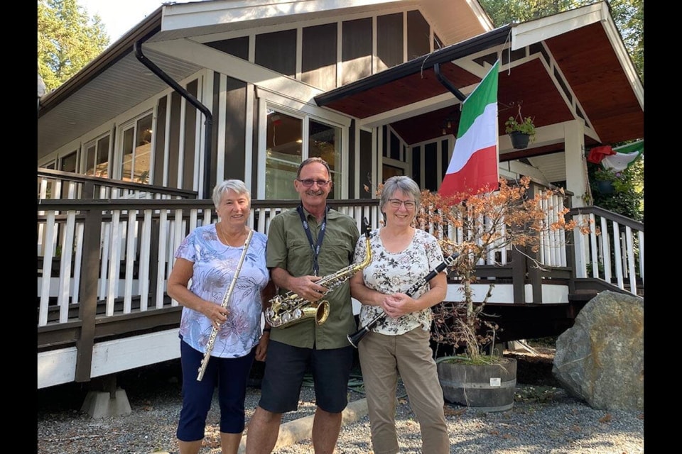 Members of the Cowichan Valley Concert Band Norma Pannell (left), Don Ballard, and Marta Swain pose in front of the Italian Kitchen and Deli located in Duncan last year.