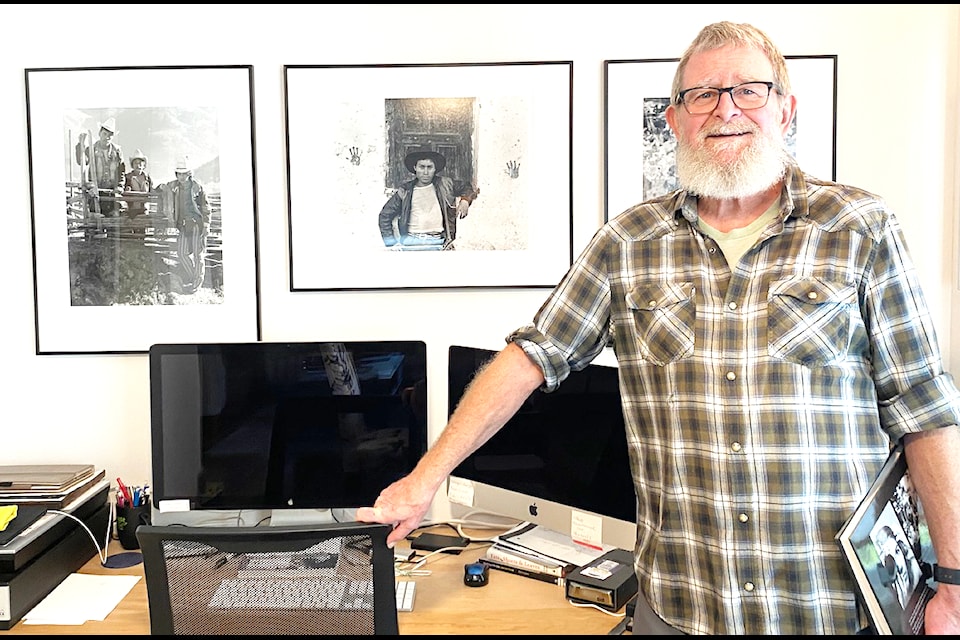 Photographer Craig Richards stands inside his Mill Bay home in front of some of the portraits he captured while in Guatemala. 