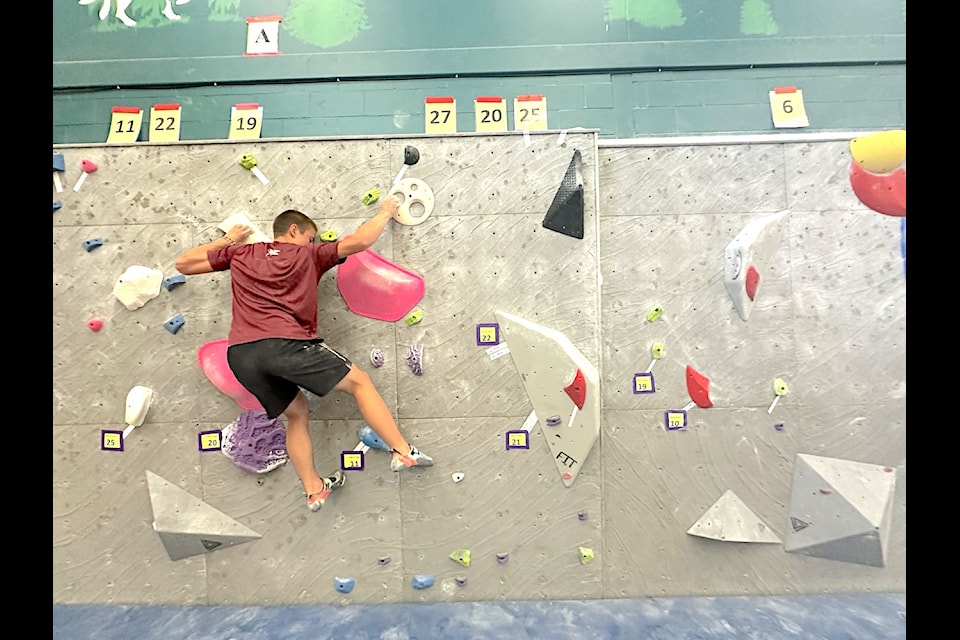 Qwu'utsun Secondary 11th grader Isaac Montes climbs during the Choc and Chalk Bouldering Competition at École Mt. Prevost School on Monday, Sept. 9.
