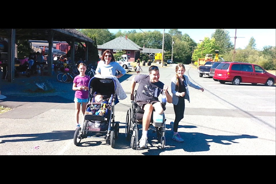"Charlie Newman leads a group across the finish line at the Terry Fox Run. The numbers were impressive for the 2014 run on Sunday, September 14. Seventy-eight participants, and 26 volunteers made the
annual run another success in Lake Cowichan which raised a total of $1,535 for the cause. The event has become a community family one at the lake with runners, walkers and kids on bikes joining in the event and then staying to enjoy hamburgers cooked up by the folks at Jakes at the Lake."