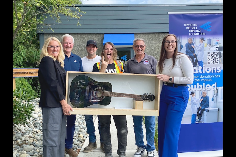 There was much excitement at  the Cowichan District Hospital Foundation on Aug. 19 as Chelsea Banner felt like a 'rockstar' winning the acoustic guitar autographed by Nickelback. CDHF CEO Naomi Low (l), David Robertson (CDHF Board Chair), Garrett D’Argis (Houle, VI Superintendent), Chelsea Banner (Winner), Phil Venoit (Financial Secretary IBEW Local 230), and Molly MacShannon (RBC Community Manager)
(Chadd Cawson/ Citizen)