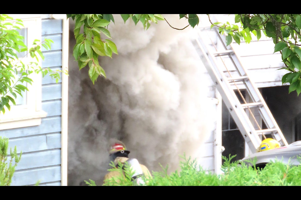 Police were called to a domestic dispute at a home on Westridge Road on Aug. 16 in which a man was later arrested. A fire also gutted the home. Pictured are North Cowichan firefighters on scene. (Cheryl Trudell photo)                                                                           
