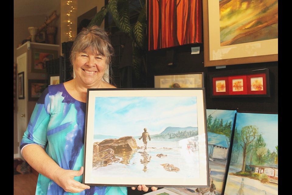Local artist, and talent Sylvia Swift holds up her painting 'Reflections on Water' which doubles as the name for her free art exhibit which will run out of the smaller Annex gallery located on the main floor of the Cowichan Valley Community Centre from Jan. 20 to Feb. 4.
(Chadd Cawson/Citizen) 