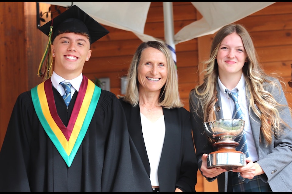 Senior athletes of the year Carter Zuback and Layla Walker flank QMS director of athletics Lucy Smith.