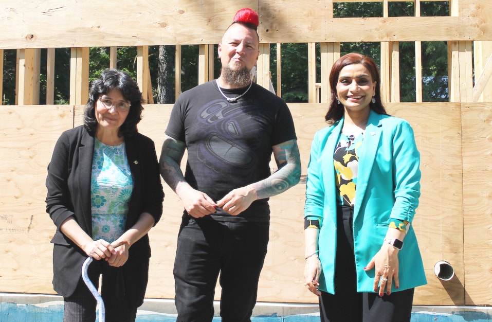 MLA and Cowichan Tribes member Debra Toporowski (left), Salish educator, and traditional-foods chef Jared “Qwustenuxun” Williams, and B.C.'s Parliamentary Secretary for Agriculture Harwinder Sandhu pose outside of the commercial-quality kitchen Williams is building to compliment the traditional smokehouse on his property. (Chadd Cawson/Citizen)