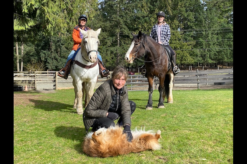 Alpine Stables owner Carla Sabourin poses with her dog Tessa, seasoned guides Andrea Geis, left, and Sam Ellis and horses Rue and Blue. (Chadd Cawson/Connector)