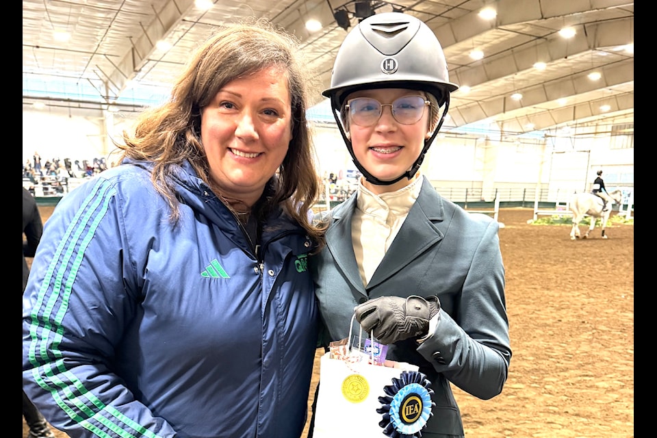 QMS Coach, Indiana Wynne-Smith, congratulates Julie Wynne-Smith after placing first and punching her ticket to the IEA National Championships in St. Louis, MO.