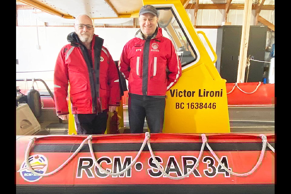 RCM-SAR 34 director of fundraising Ross Pierce (left) and coxswain Mark Winfield stand on their rescue boat inside their boathouse in Cowichan Bay. RCM-SAR celebrates their fifth online fundraising auction that will be open for bidding from March 15 to the 22. (Chadd Cawson/Citizen)