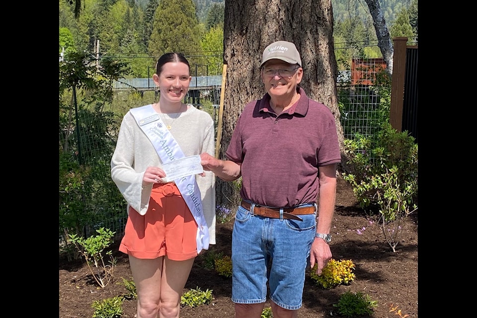 A $1,000 cheque presented by Richard Weir to B.C. Ambassador candidate Jenae Weir.