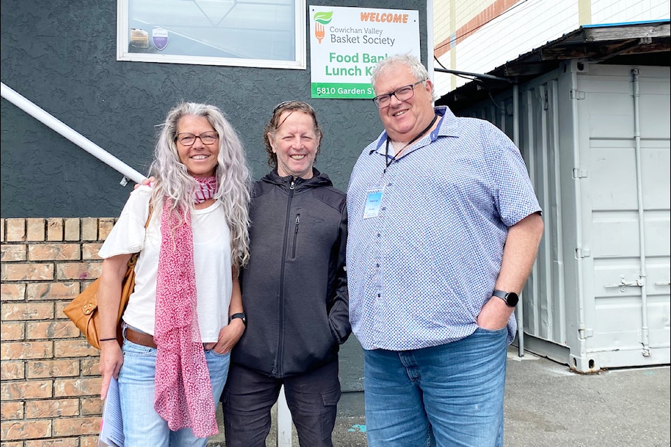 Wayne Bourgeois (centre) is marking the milestone of his 65th birthday with the fundraiser 'Sixty-five and Feeding Lives' to assist the needs of the Cowichan Valley Basket Society. Bourgeois's friend and co-worker Jody Hunniford, and CVBS manager Henry Wikkerink  stand on either side of in front of the Duncan food bank.
(Chadd Cawson/Citizen)