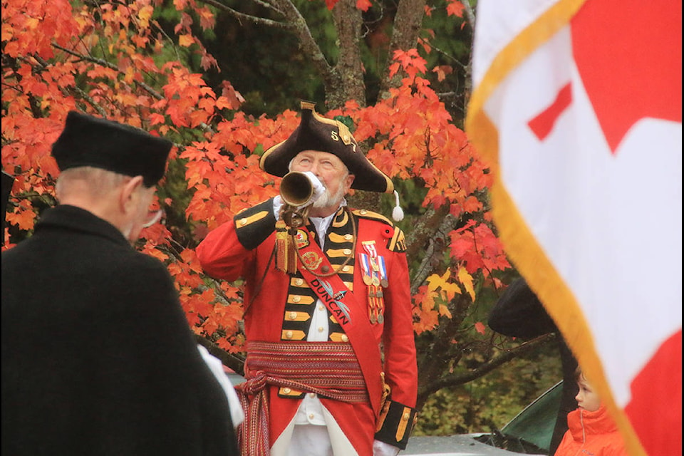 Duncan Town Crier Ben Buss plays ‘The Last Post’ during ceremony at Cobble Hill cenotaph for