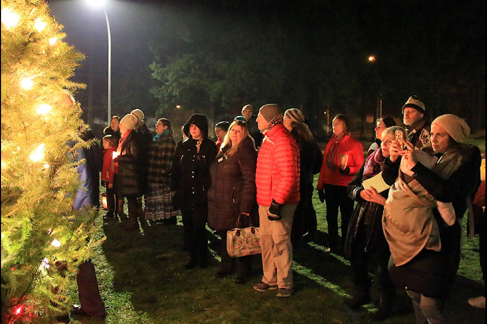Members of the Threshold Choir and the general public admire the beauty and significance of the fully lit Tree of Remembrance outside Cowichan District Hospital on Dec. 6. (Lexi Bainas/Citizen)