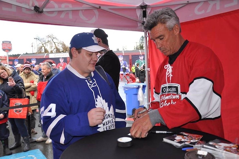 An unabashed Toronto Maple Leaf fan gets an autograph from Geoff Courtnall at Rogers Hometown Hockey in Cowichan. (Warren Goulding/Citizen)