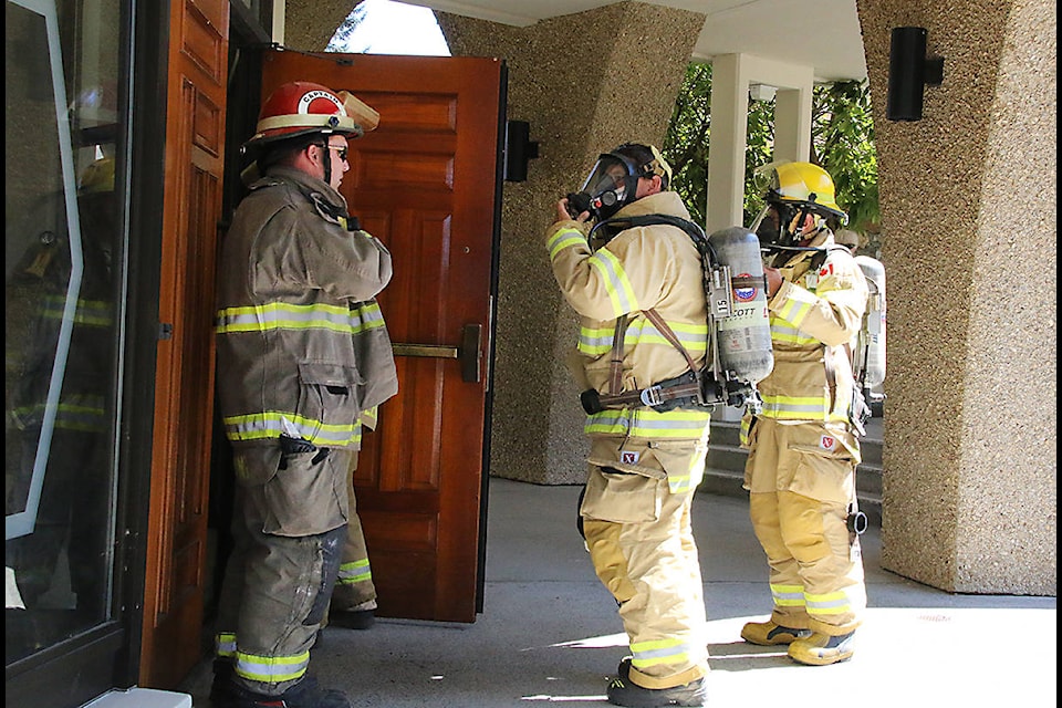 Firefighters wearing Scott air packs enter the Round Building in Duncan after a call-out about smoke through the structure. (Lexi Bainas/Citizen)