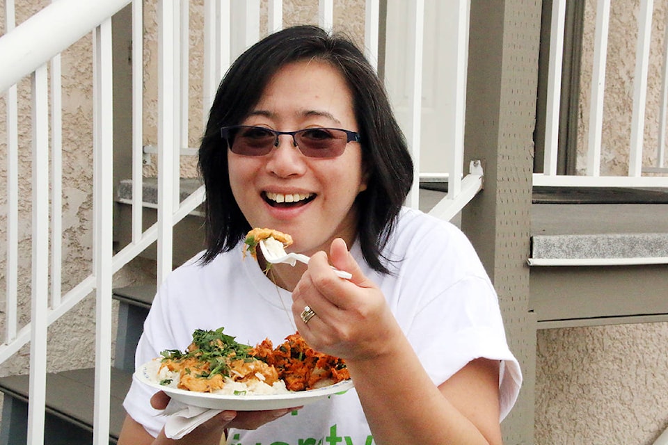 Jennifer Yee Fairweather enjoys some of the delicious food available at the One World Festival on Saturday, Sept. 22. (Lexi Bainas/Citizen)