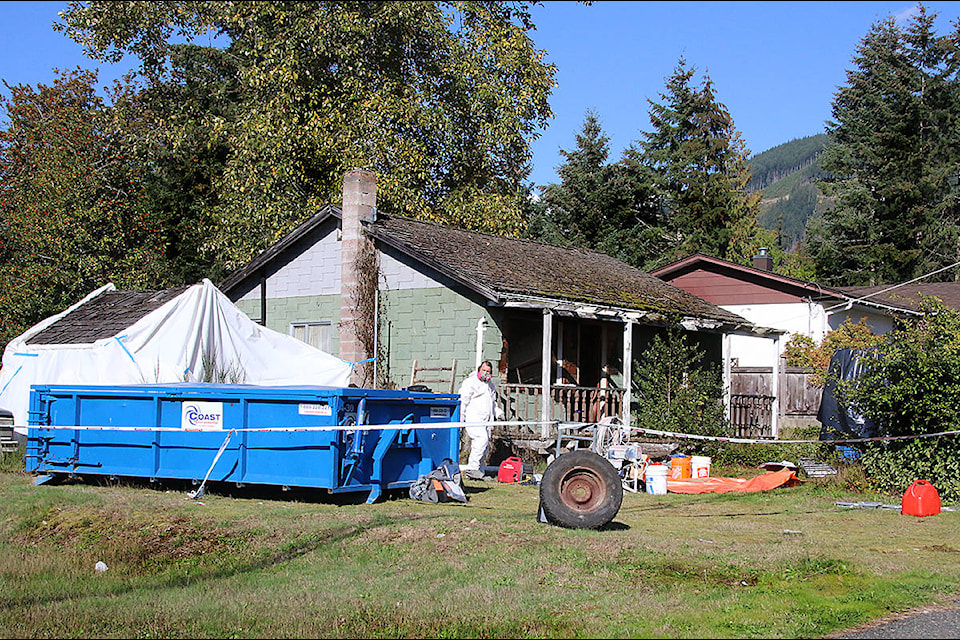 A hazmat team is at work at 182 Neva Rd., part of the demolition work planned for a building declared derelict by the Town of Lake Cowichan. (Lexi Bainas/Gazette)