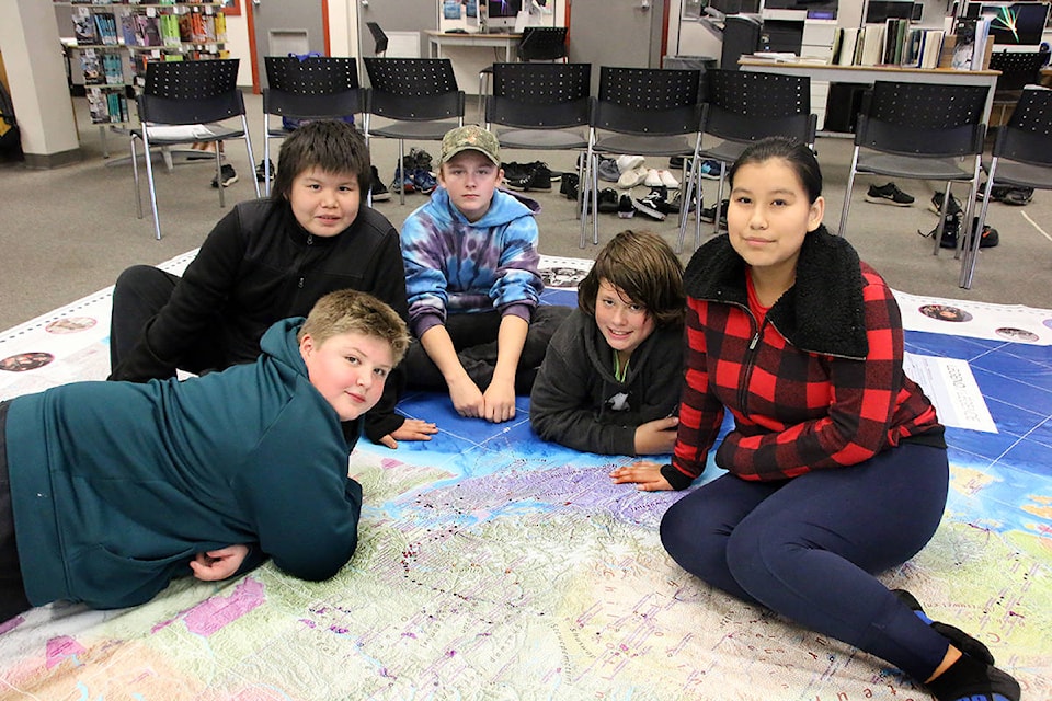 Students from Miss Myhre’s class enjoy checking out the huge map of Canada. (Lexi Bainas/Citizen)