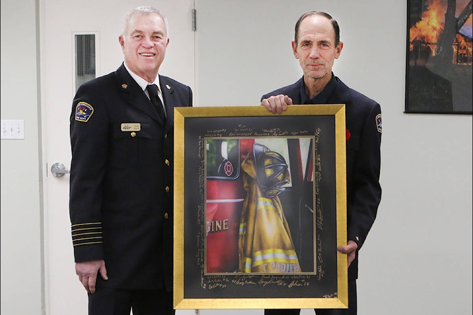 Top left: Lake Cowichan Fire Chief Doug Knott presents a painting signed by all department members to Tom Padjen on his retirement after 30 years of service. (Lexi Bainas/Gazette)