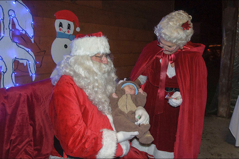 Nash Burgan meets Santa and Mrs. Claus for the first time at the Lake Cowichan Santa Claus Parade Sunday, Nov. 25. (Malcolm Chalmers photo)