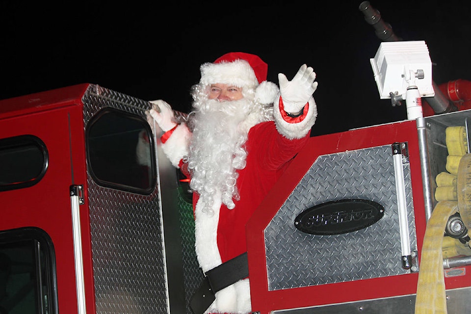 What’s a Christmas parade without Santa Claus? Santa was indeed there to wave to the crowd at the Crofton Christmas parade Sunday night. (Photo by Don Bodger)
