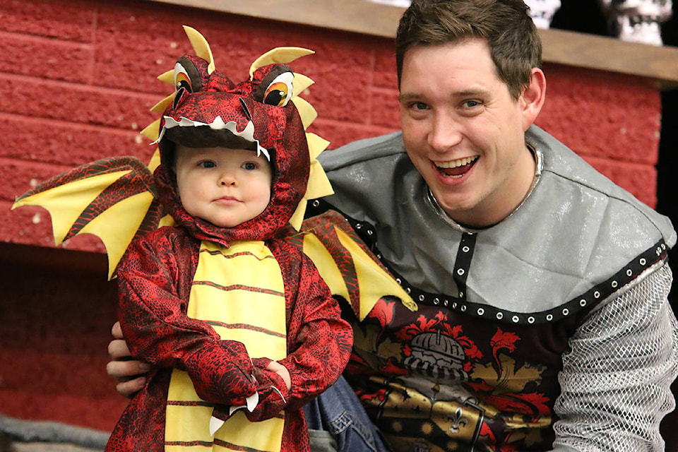 Being on stage with dad makes it much easier during the Halloween costume contest at Youbou Hall. (Lexi Bainas/Gazette)