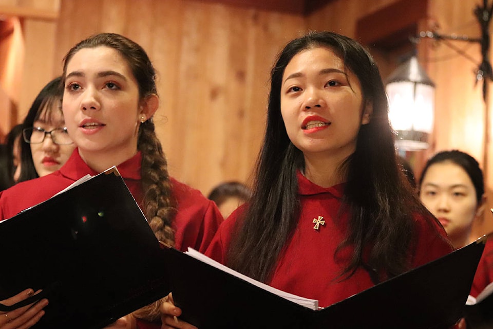 Maxine Creery and Susanna Cai sing during the Queen Margaret’s School annual candlelight service at the QMS chapel. (submitted)