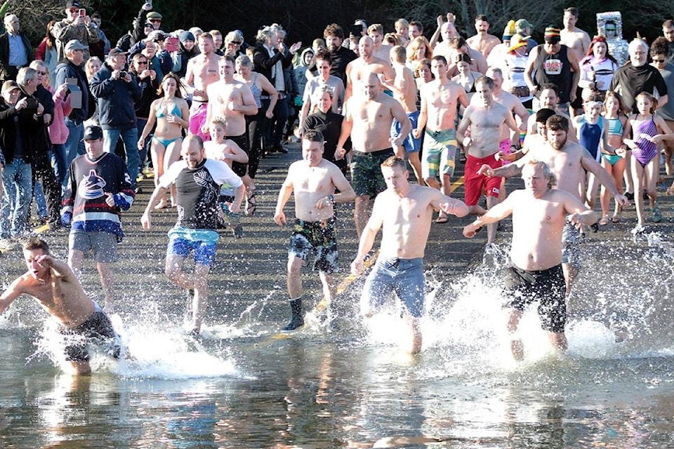 Swimmers run into Cowichan Bay to celebrate the start of 2020 on Wednesday, Jan. 1. (Kevin Rothbauer/Citizen)