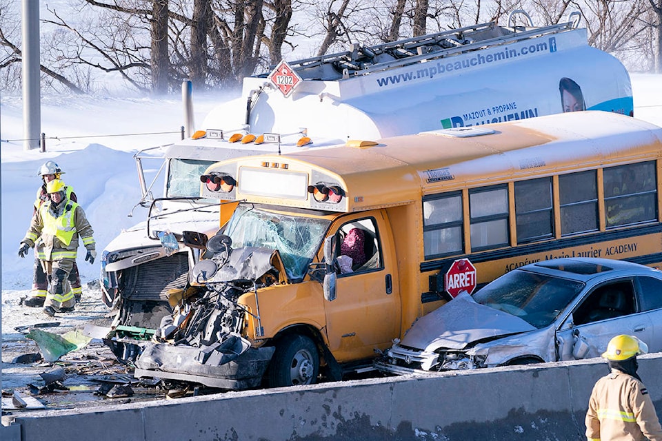 A fireman walks past a massive pileup involving numerous vehicles on the south shore of Montreal in La Prairie, Que. on Wednesday, February 19, 2020. THE CANADIAN PRESS/Paul Chiasson