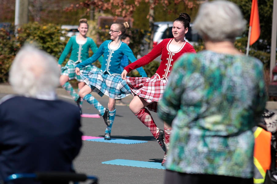 Celtic Rhythms dancers (from front to back) Breanne Smith, Morgan Woiden and Austyn Woodward perform outdoors for residents of Ts’i’ts’uwatul’ Lelum on April 9. (Kevin Rothbauer/Citizen)
