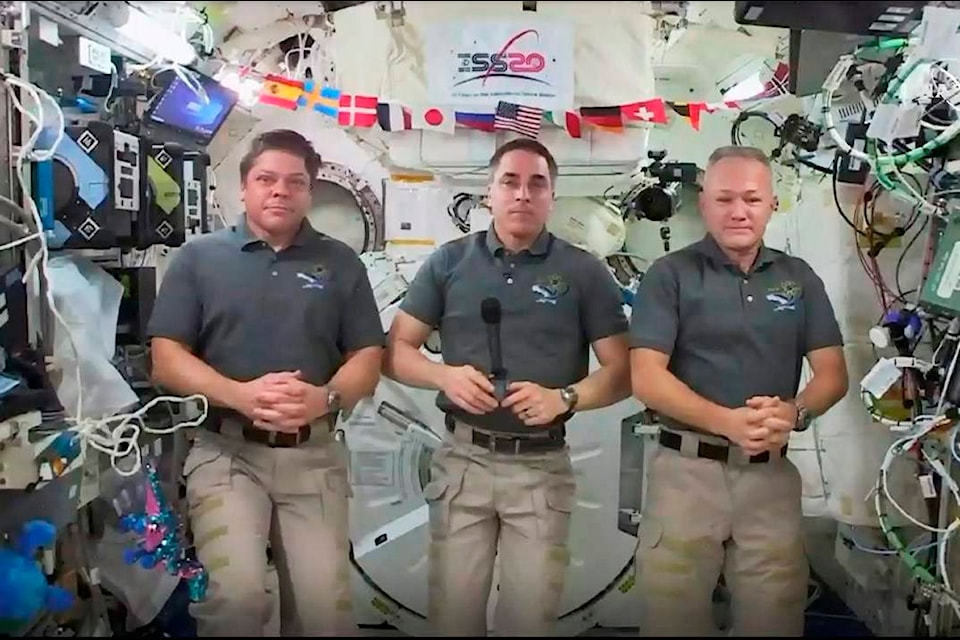 This photo provided by NASA shows from left, astronauts Bob Behnken, Chris Cassidy and Doug Hurley during an interview on the International Space Station on Friday, July 31, 2020. Behnken and Hurley are scheduled to leave the International Space Station in a SpaceX capsule on Saturday and splashdown off the coast of Florida on Sunday. (NASA via AP)