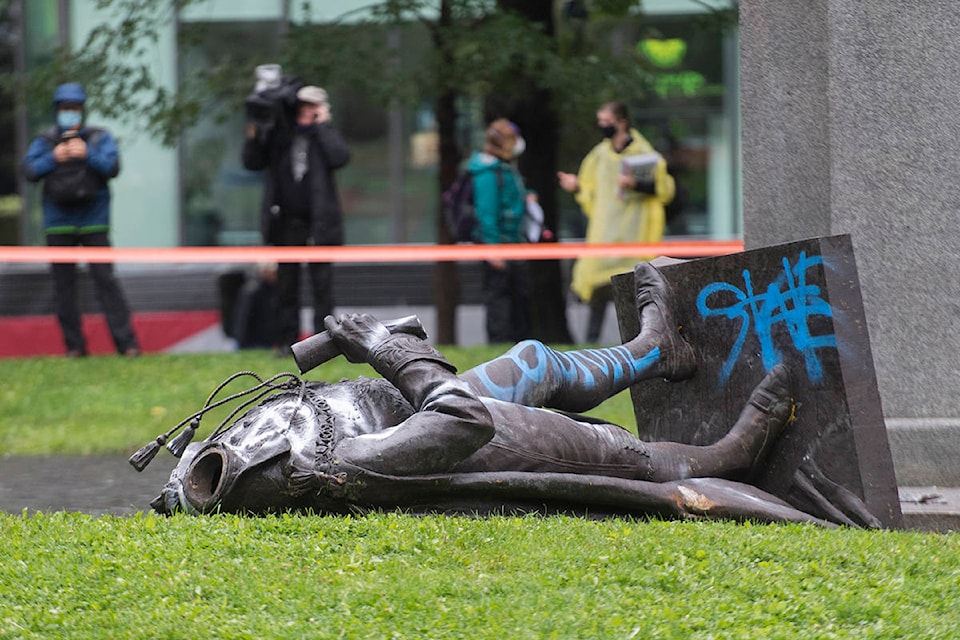 The statue of Sir John A. MacDonald is shown torn down following a demonstration in Montreal, Saturday, Aug. 29, 2020, where they protested to defund the police with a goal to end all systemic racism within all sectors of the Canadian government. THE CANADIAN PRESS/Graham Hughes