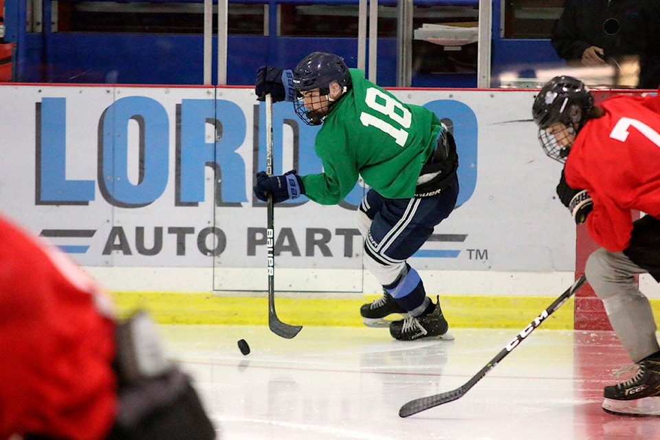 Green forward Jareden Kurvers (18) is pursued by Red defenceman Nathan King (7) during the all-star game at the Cowichan Valley Capitals rookie camp on Sunday, Aug. 22. (Kevin Rothbauer/Citizen)