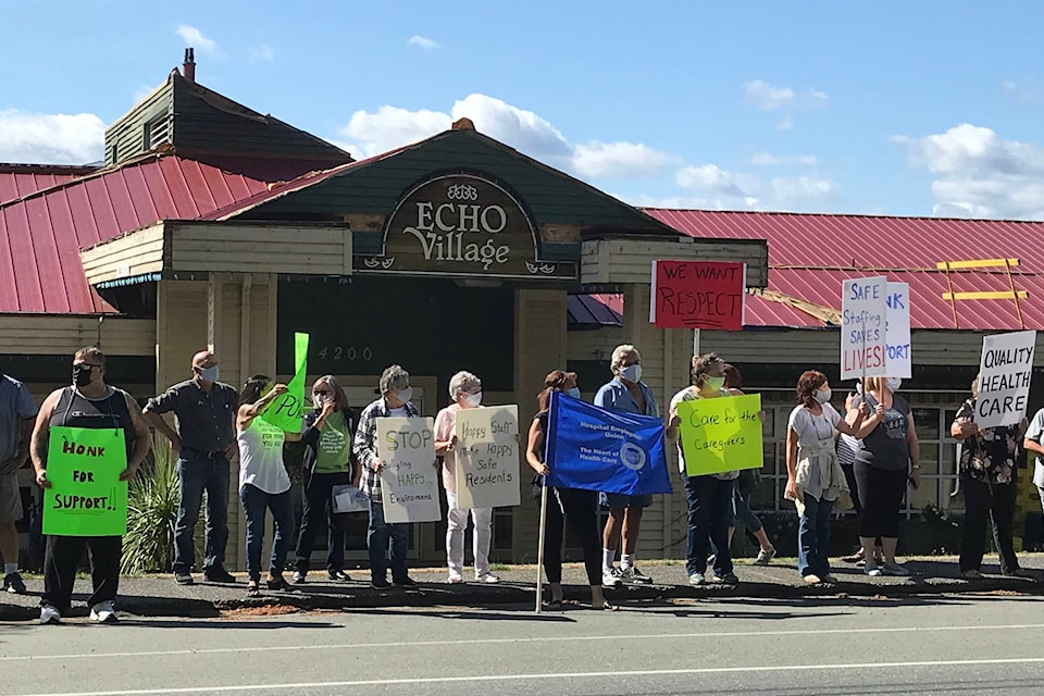 Close to 75 protesters with signs marched between FIr Park Village and Echo Village long-term care homes in Port Alberni on Tuesday, Aug. 31, 2021 to advocate for better conditions and management at the facilities. (SUSAN QUINN/ Alberni Valley News)