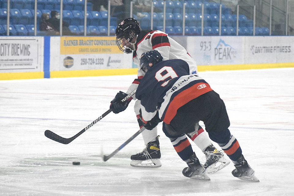 Nathan MacDonald of the Port Alberni Bombers keeps the puck away from a Kerry Park defender during the Bombers’ home opener on Wednesday, Sept. 15, 2021. (ELENA RARDON / ALBERNI VALLEY NEWS)