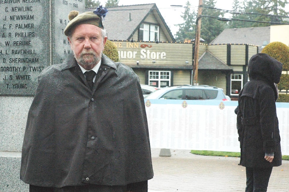 Bob Collins, a former member of the Queen’s Own in Winnipeg, stands at attention on Oct. 22 at Cobble Hill Cenotaph to honour members of the Canadian military who died in Canada in non-combat roles. (Robert Barron/Citizen)