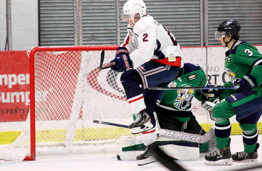 Cowichan Valley Capitals defenceman Colin Campbell does his best to avoid Surrey Eagles goaltender Max Prazma after a scoring chance during the teams’ BCHL game last Saturday. (Kevin Rothbauer/Citizen)