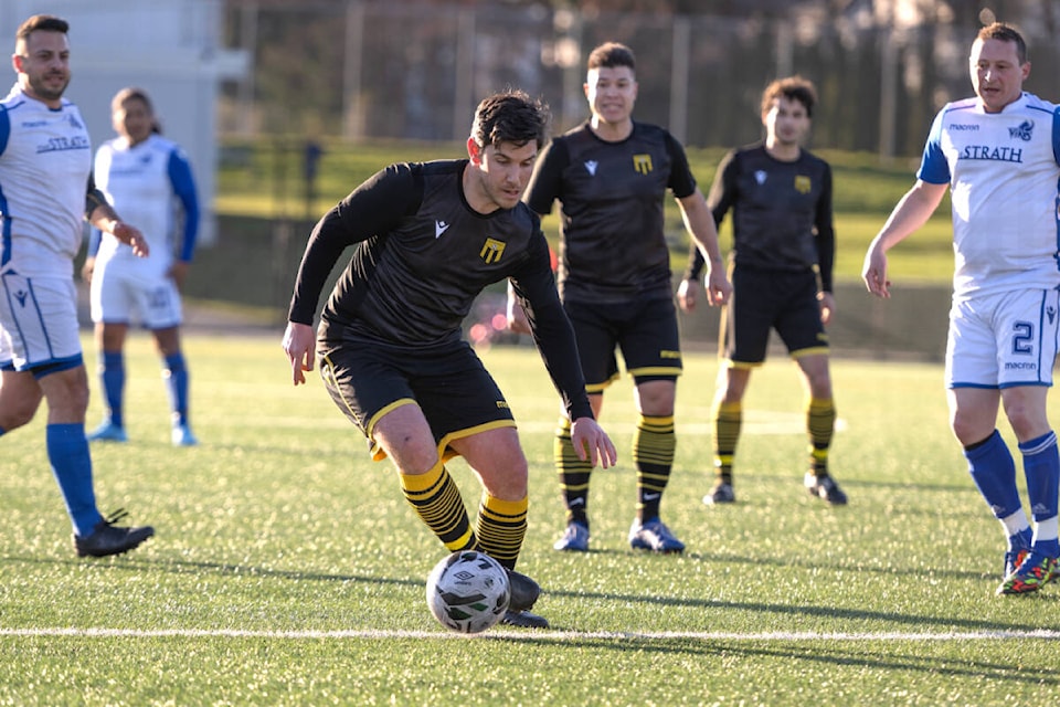 Brad Archibald leads the Cowichan 49ers up the pitch during last Saturday’s O35A league finale against UVic Alumni. (Todd Blumel photo)