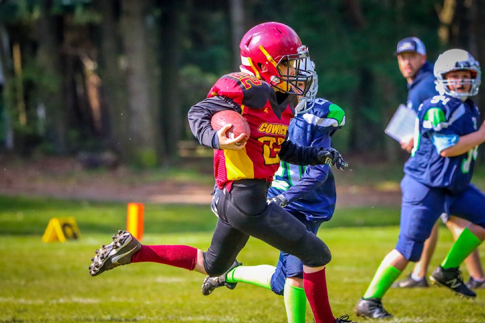 Harrison Plaxton gains yards for the atom Bulldogs in their win over Nanaimo Blue. (Jen Laver photo)