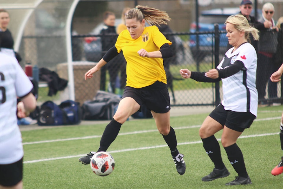 Hat-trick scorer Stacey de Lusignan weaves through the Langley Lunachicks defence during the Cowichan Cougars’ decisive win in the provincial semifinal at the Sherman Road turf last Saturday. (Kevin Rothbauer/Citizen)