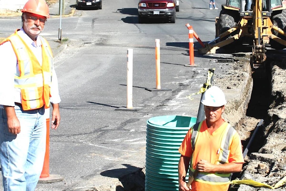 “Superintendent of Public Works, Nagi Rizk (left), supervises crews on South Shore Road as they prepare for the installation of median islands as part of the town’s downtown revitalization plans.” (Lake Cowichan Gazette/Sept. 5, 2012)