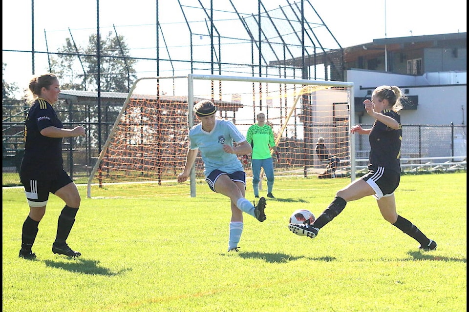 A Castaways defender wants to clear the ball from her own zone but midfielder Monni Savory has other ideas. (Sarah Simpson/Citizen)