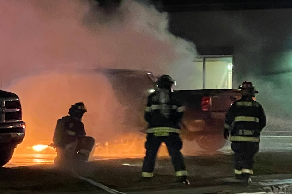 Firefighters battle vehicle fires Wednesday morning between the Sunshine Inn and CIBC on Fourth Avenue in Smithers. (Contributed photo)